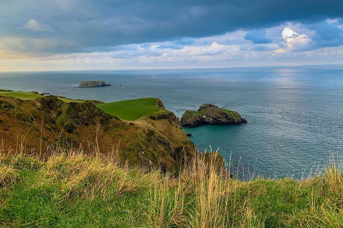 Northern Highlights Full-Day Guided Tour in Northern Ireland - Cushendall area breaks: curfew tower, hurling murals, and ruins
